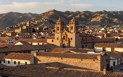Historic center of Cusco with terracotta rooftops and Incan ruins, representing traditional Peruvian heritage and culture